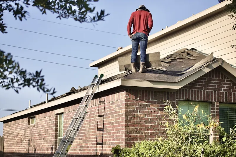 Professional roofer working on a residential roof in Rustic Hills